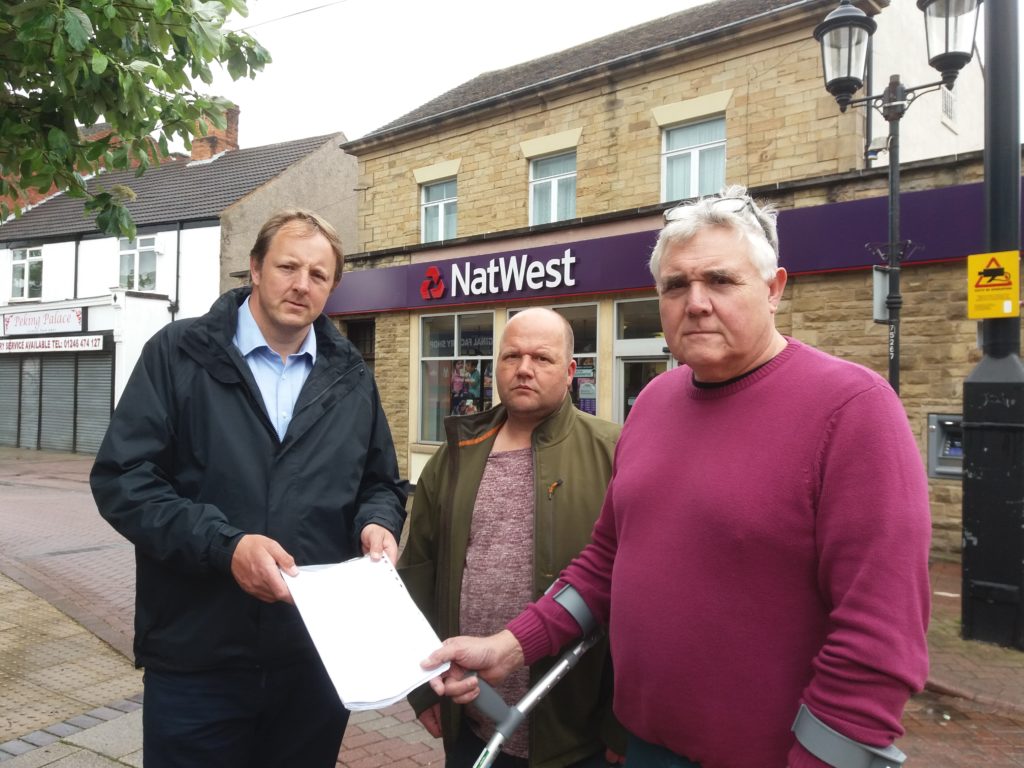 Toby with Keith Bannister, right, the owner of Tillys Bar and Harley's Bar in Staveley and Tony Kay from Kay's Carpets with a 900 name petition against the closure of the town's NatWest branch